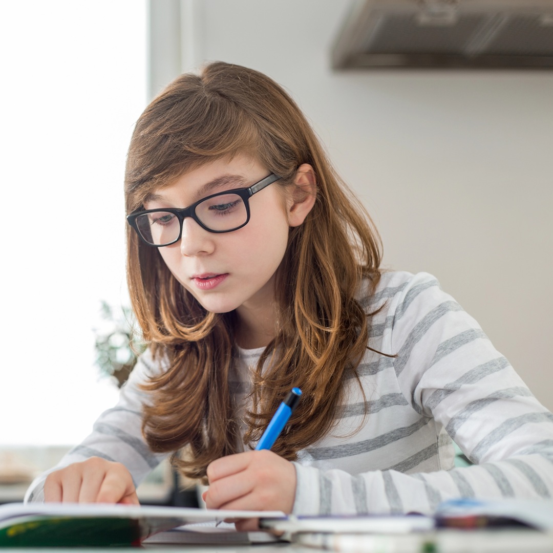 Tyttö tekee koulutehtäviä.